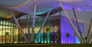 Glass building with many different LED spotlights in the dark