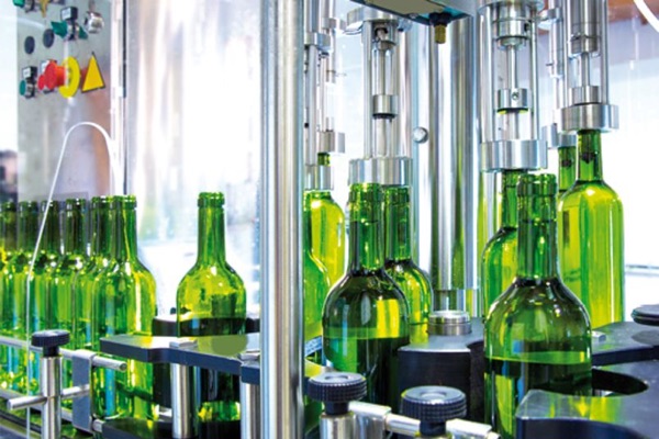 green glass bottles in dispensing equipment