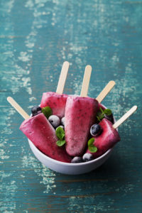 Melon ice cream in a bowl with berries