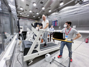 several Menshcen on a climate simulator on a treadmill