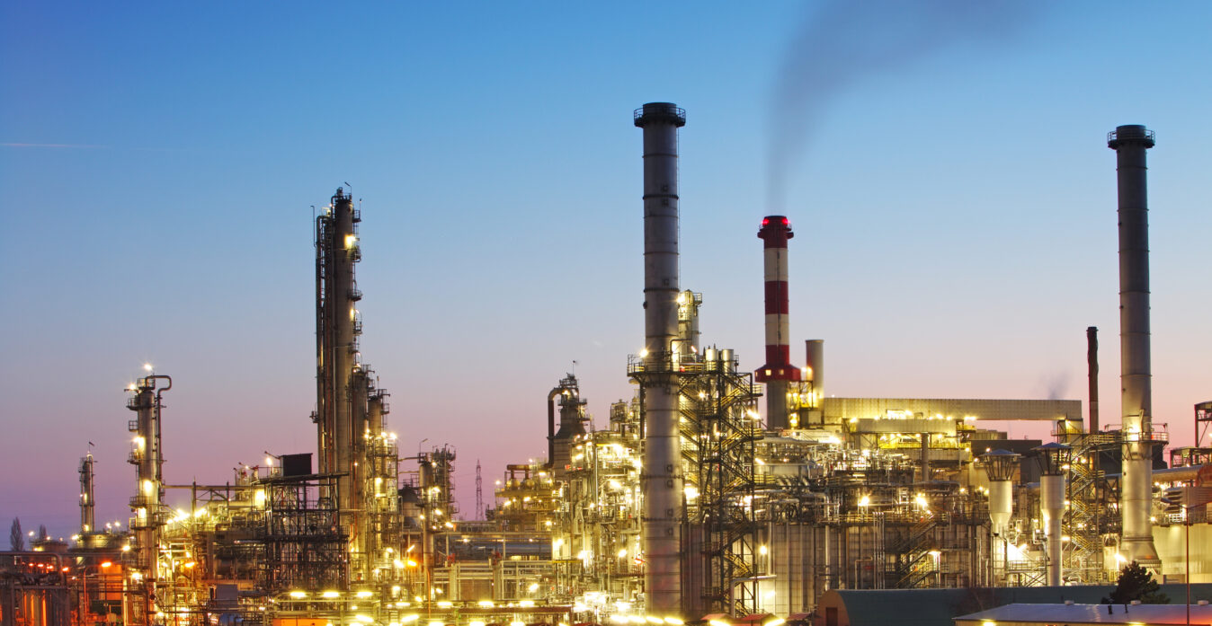 Oil and gas refinery at twilight with reflection - factory - petrochemical plant